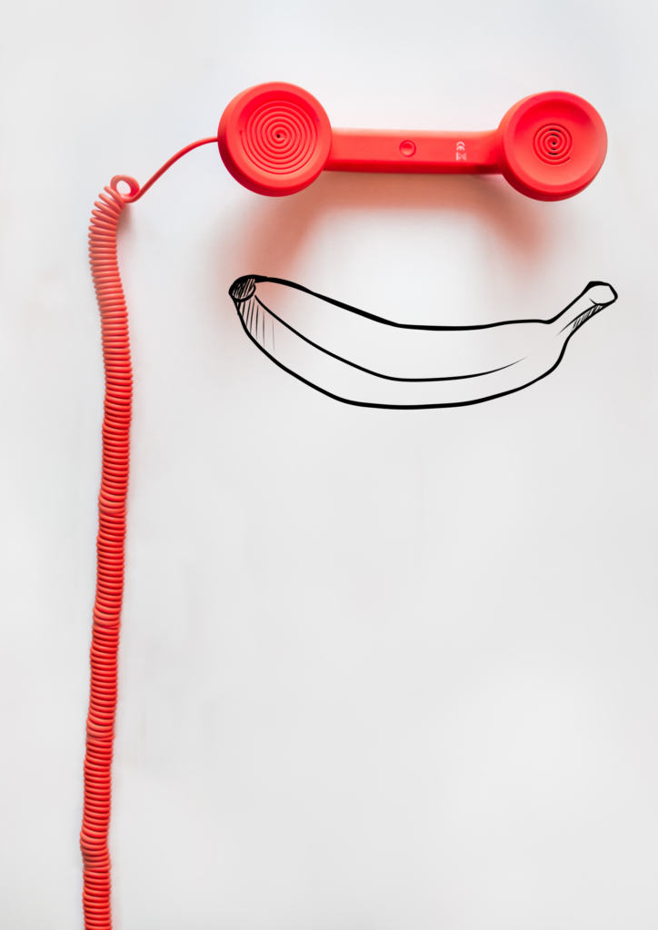 an image of a red telephone handset with a drawn banana underneath to reach astraea flora retreat booking. So, book Psilocybin experience today.